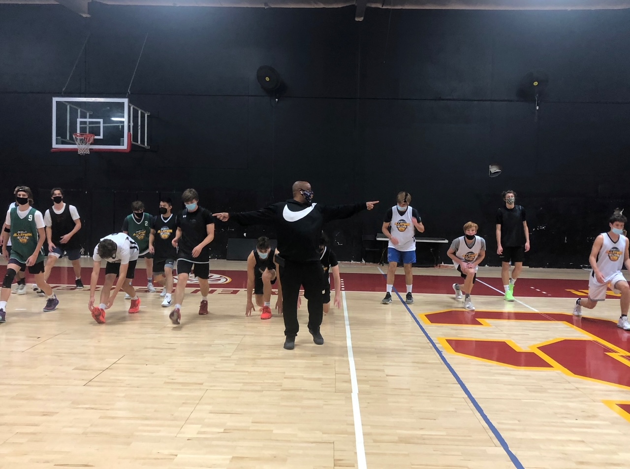 Coach Ray guiding players on court