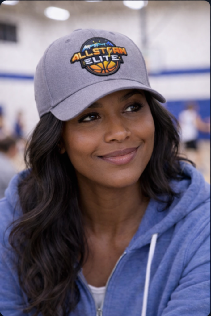 Parent wearing AllStorm Elite heather gray embroidered baseball cap at youth basketball game